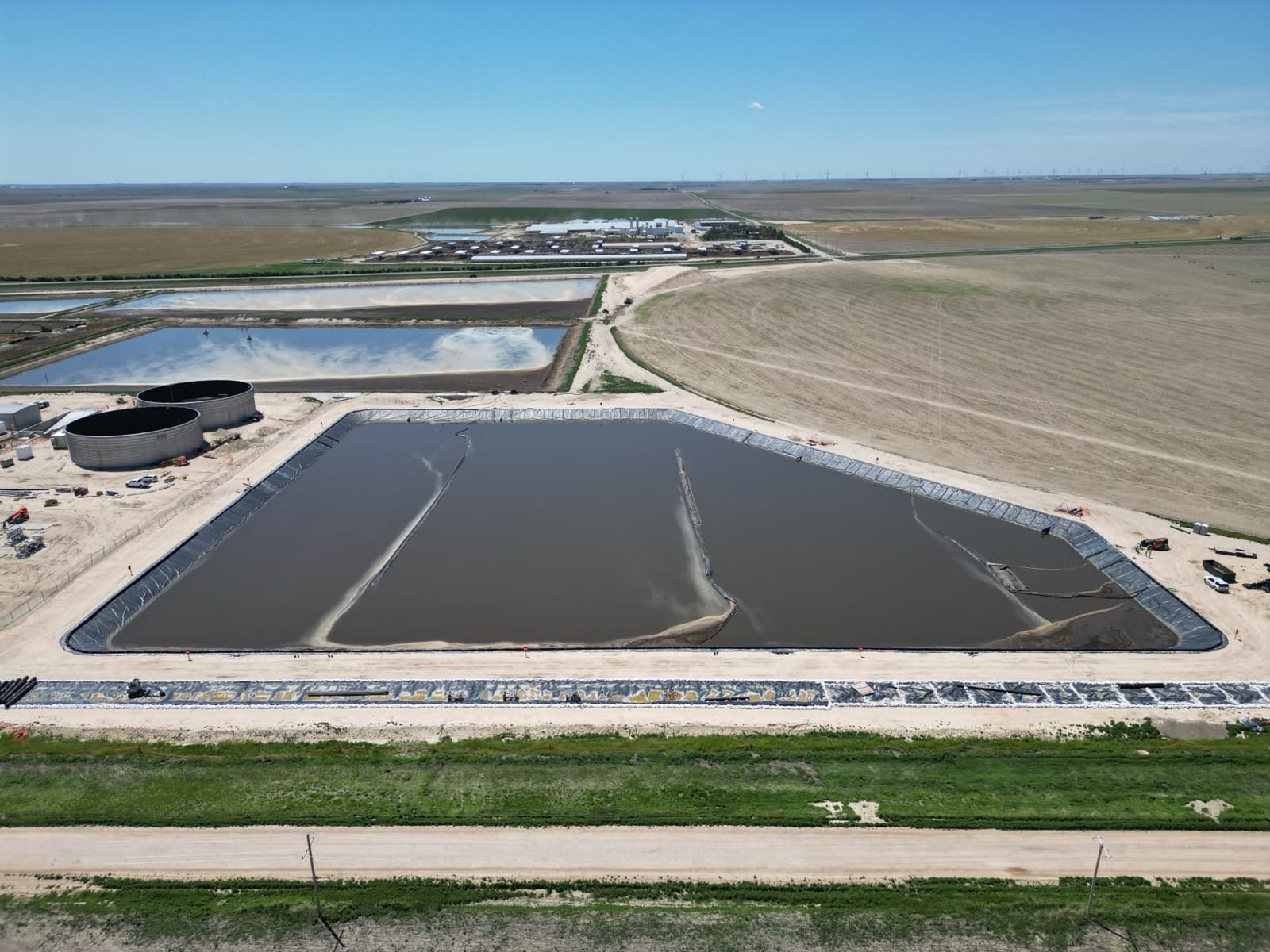 Floating baffle installation in lagoon