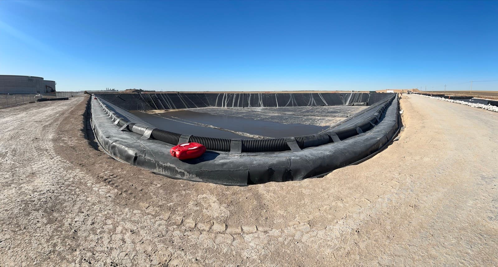 Floating membrane cover deployment on lagoon