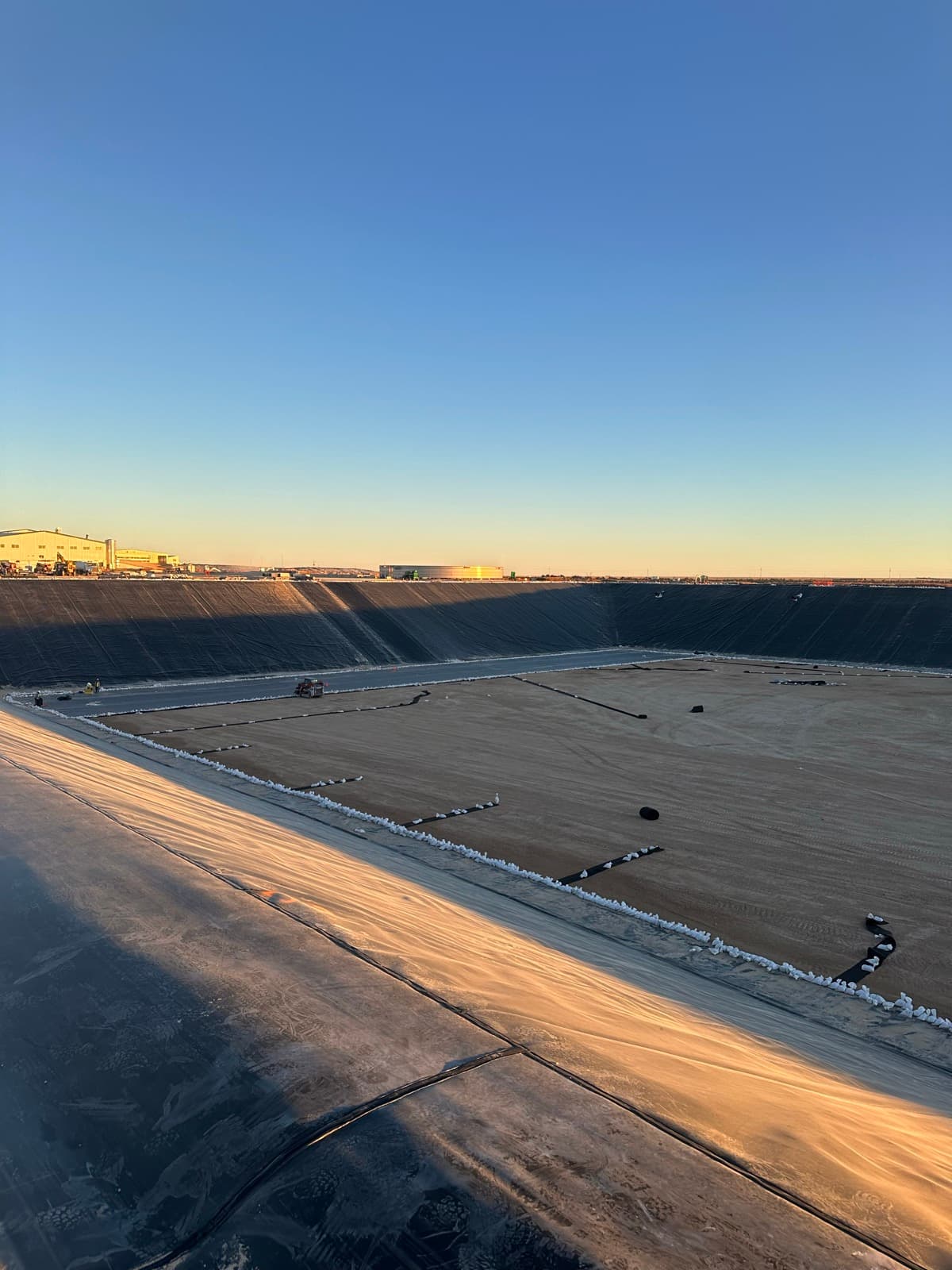 HDPE liner panel deployment across lagoon